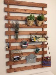 Repurposed Ikea Bed Slats Stained Drilled Into 1 X1 Boards Decorated With Grundtal Ikea Hooks Baskets Ikea Bed Slats Bed Slats Apartment Decorating Ikea
