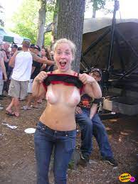 Weird blonde teen chick flashes her perky tits at a rockfest -  NakedOnTheStreets.com