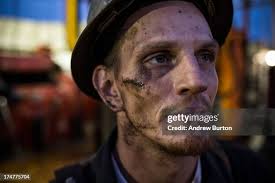 Glen Crabtree, a floor hand for Raven Drilling, waits to line up pipe...  News Photo
