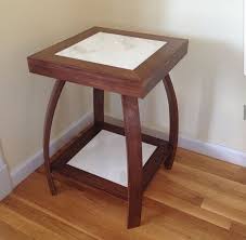 A Small Wooden Table With Bent Legs Used Marble Tiles As Inlays On Both Top And Bottom Table Marble Tiles Home Decor