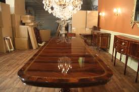 Large dining room featuring a tall and stunning ceiling. Extra Large And Wide Mahogany Dining Room Table