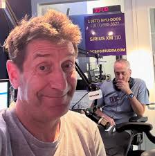 The ENT show starts soon, and host Dr. Sean McMenomey (seen in this studio  selfie) is at the mic and ready to talk finding a Speech Language  Pathologist for post-COVID issues, from