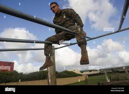A U.S. Marine with Marine Corps Forces, Pacific goes through the obstacle  course during morning physical training at Landing Zone Boondocker, Marine  Corps Base Hawaii, April 14, 2018. The Marines from MARFORPAC