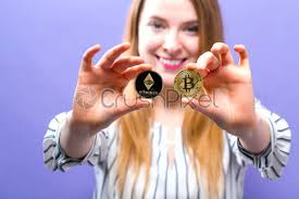 Unlike what the name may suggest, ethereum 2.0 is a technical upgrade of the ethereum blockchain. Woman Holding Physical Bitcoin And Ethereum Coins Stock Photo Crushpixel