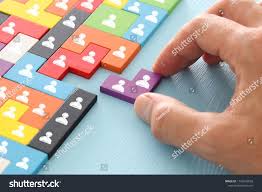 Working with a pencil and paper is one of the most satisfying ways to solve puzzles. Image Of Tangram Puzzle Blocks With People Icons Over Wooden Table Human Resources And Management Concept Blocks People Cool Fonts Business Design People Icon