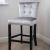 Benjara 24 contemporary solid wood saddle top counter stool in brown/beige. 1