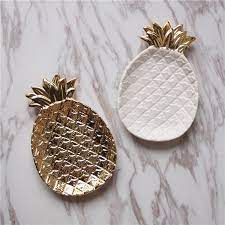 A pretty little gold pineapple tray to bring some glam to your home. Gold Pineapple Ceramic Storage Tray Golden Jewelry Food Pallet Dry Fruit Plate Home Decoration Plate Ceramic Pineapple Pineapple Jewelry Gold Pineapple Decor