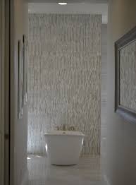 Textured finishes and graphic mosaic patterns are trending among tiling ideas for bathrooms. Three Tile Ideas For Stunning Shower Designs Tile Outlets Of America