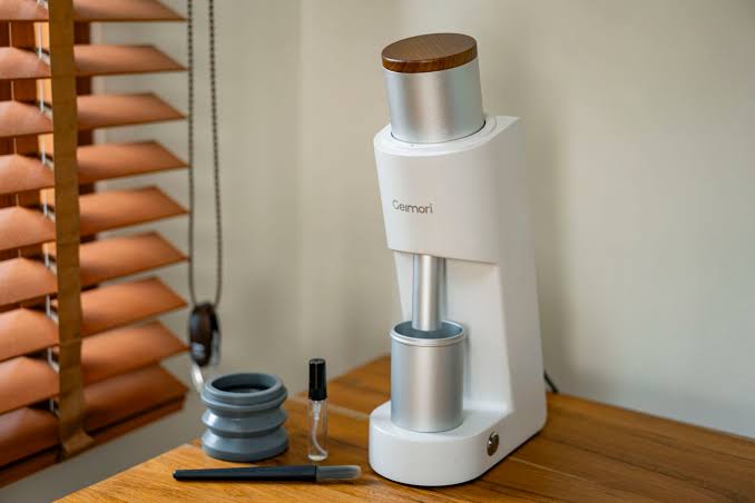 A modern single-dose grinder with its catch cup, AI generated