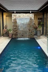 This Courtyard Pool Area Is Completed By The Water Feature The Space Has Been Designed With Tranquility In Mind And The Runn Courtyard Pool Pool Pool Builders
