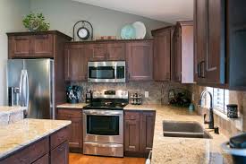 Praline, a golden finish with yellow overtones, heightens the natural beauty and unique characteristics of maple wood this full overlay door style leaves very little cabinet frame showing around each door and drawer front, creating a living space with a modern, seamless appearance Maple Cabinets In A Praline Stain Microwave Above Range Aspect Cabinetry Kitchen Design Kitchen Remodel New Kitchen Cabinets