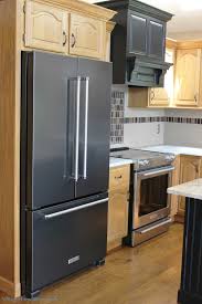 Black And Stainless Steel Refrigerator Partial Remodel How To Pull Off Mixing Metals Village Home Stores Kitchen Remodel Black Stainless Appliances New Kitchen