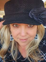 My Elvira earrings I got at Sinister Con 2023 and me in costume 😀