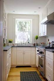 A Small Kitchen In Black White I Like The Tall Ceiling Hight Cabinets In This Small U Shap Kitchen Remodel Layout Kitchen Remodel Small Kitchen Remodel Cost