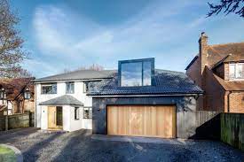 The centerpiece of the converted guest quarters is the original garage door, which was painted a cheery orange color. Garage Conversions How To Cost Design And Plan Your Project Real Homes