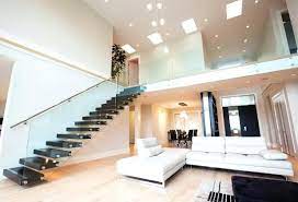 An interior of a modern house boasting a very stylish staircase with glass railings. Stairs Inside House By Putra Sulung Medium
