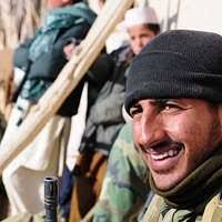 An Iraqi Soldier secures three suspected insurgents after a raid near  Kirkuk, Iraq, during Operation IRAQI FREEDOM. The Soldier is armed with a  Tabuk 7.62 mm assault rifle with a folding double