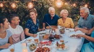 A Family Sit Around A Dinner Table Eating And Laughing Summer Recipes Romantic Dinner For Two Healthy Summer Recipes