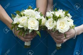 Whether looking for fall wedding bouquets with purple flowers for a vineyard wedding, winter wedding bouquets with classic white wedding flowers, colorful summer flowers for a tropical wedding, or some other unique theme , our floral experts can put together the bouquet of your dreams. Two Bridesmaids In Blue Holding Wedding Bouquets Of White Roses Stock Photo Picture And Royalty Free Image Image 15167103