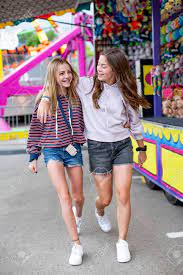 Candid Photo Of Two Cute And Smiling Teenage Girls Having Fun At An Outdoor  Carnival Or Theme Park. Teenagers Enjoying Their Summer Vacation. Stock  Photo, Picture and Royalty Free Image. Image 142905605.