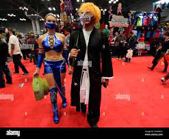 A woman dressed as Kitana, a character from the Mortal Kombat media  franchise, left, and a man dressed as the character Ichigo Bankai attend  the first day of New York Comic Con,