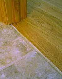 Grout Joint Between Hardwood And Tile Transition Without Moldings Hardwood Tile Transition Wood Laminate Flooring