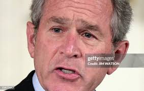 Father Dan Dunham wipes away a tear as mother Debra Dunham holds the...  News Photo