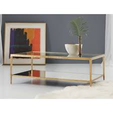 Inspired by art deco style, the sculptural brass coffee table's crossed iron frame is finished in antique brass, bringing a floaty elegance to living rooms. Luxury Brass Coffee Tables Perigold