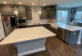 The background of this quartz countertop is a beautiful deep black, and the veining is broad white streaks. Quartz Calacatta Countertops Granite Countertops Quartz Countertops Kitchen Cabinets Factory