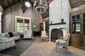 A moder rustic living room with a stone clad fireplace, wooden furniture and a leather sofa plus comfy wooden chairs. Hill Country Rustic Elegance Rustic Living Room Austin By Southern Landscape Houzz Au
