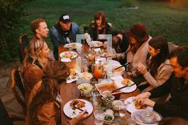 This moody fall dinner party is a total vibe. A Fall Dinner Party Outdoors Photo Lightstock