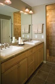 This tiny bathroom is made to feel much larger by the inclusion of mirror all around the room. Bathroom Decorating Ideas With Oak Cabinets Cabinet Chasseur