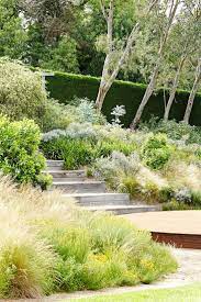 Melbourne Acreage Transformed Into Haven Of Greenery Sloped Garden Garden Landscape Design Australian Garden