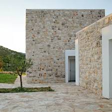 Stone From A Local Quarry Was Used For The Cladding Paving And Retaining Walls Of This Cluster Of Buildings By Dva Arh Facade Design Stone Facade Stone Houses