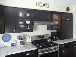 The mission door style in espresso finish complement the corian quartz cloud white countertops, and hardwood snack top. Bridgewood Cabinets Reviews Kitchen Cabinets