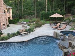 A gallery featuring a huge selection of large and small garden waterfalls with ponds and streams. Stone Waterfalls And Vanishing Edge Pool Landscaping Network