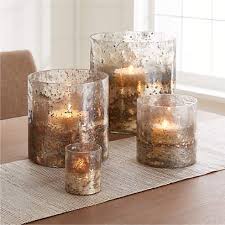 It has clear glass inlay, metal frame at the bottom part and textured clear . Sona Glass Hurricane Candle Holders Crate And Barrel