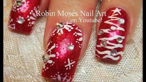 red glitter with white snowflake nails