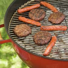 Grill out all summer long with dozens of our best recipes for burgers and hot dogs. Hot Dogs And Hamburgers Cooking On Grill Stock Photo Dissolve