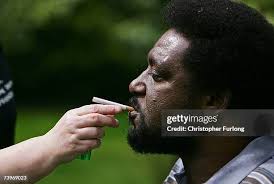 Neo-Nazi attack victim Noel Martin smokes a cigarette in the garden... News  Photo