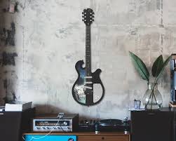 It is constructed using rosewood, giving it a nice wooden look. Guitar Metal Wall Art Guitar Wall Art Metal Wall Decor Etsy Guitar Wall Art Guitar Wall Contemporary Metal Wall Art