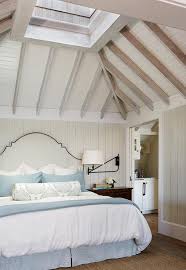 Vaulted ceilings bring a sense of openness to a home. Beach Cottage Bedroom With Vaulted Skylight Ceiling Cottage Bedroom