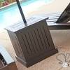 Brown wicker outdoor side table with umbrella hole. 1