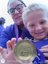 Chief Warren with the Newton Grove Police Department presenting Dana  Ellington-Ruiz with a commemorative Newton Grove Police Department Breast  Cancer patch. Also in photo is Ellington Tart Sampson County Miss Relay for