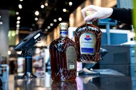 US ban on Canadian alcohol and dairy comes into effect as trade war drags on - BBC