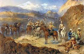 Photograph of the Khan of Lalpura, the leader of the Lalpura region of Afghanistan, and his followers on a mountainside. The Khan is standing in the middle of a group of Afghan