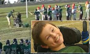 The heartwarming moment boy, 13, with cerebral palsy was brought from the  sidelines to the field to score a touchdown