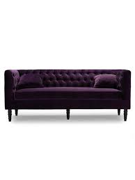 A glossy black lacquer coffee table is surrounded by facing apple green velvet roll arm chairs, a purple velvet tufted ottoman, and light gray linen roll arms of an accented with blue and purple pillows. Purple Velvet Tufted Sofa Modern Furniture Brickell Collection