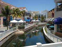 Airy, clean and welcoming, the plaza is eclectic in its mix of national and international brands, navigable waterways, and an interactive aquarium where you can swim with dolphins and sharks; La Isla Shopping Mall Cancun Mexico Cancun Vacation Cancun Shopping Cancun