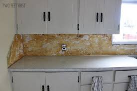 We pulled ours off without changing the cabinets. Removing Laminate Backsplash